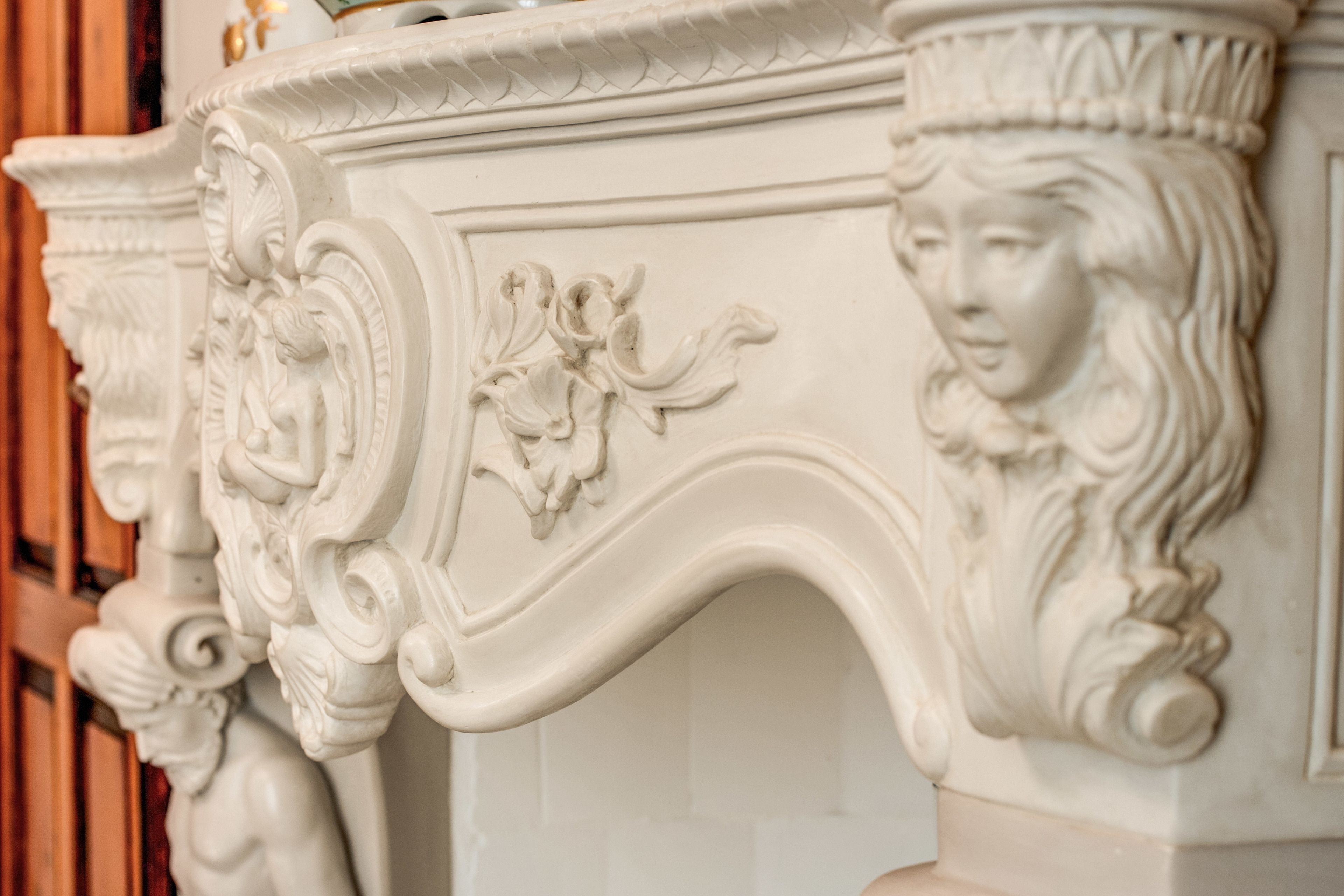 A detailed white architectural feature with ornate carvings and a curved design.
