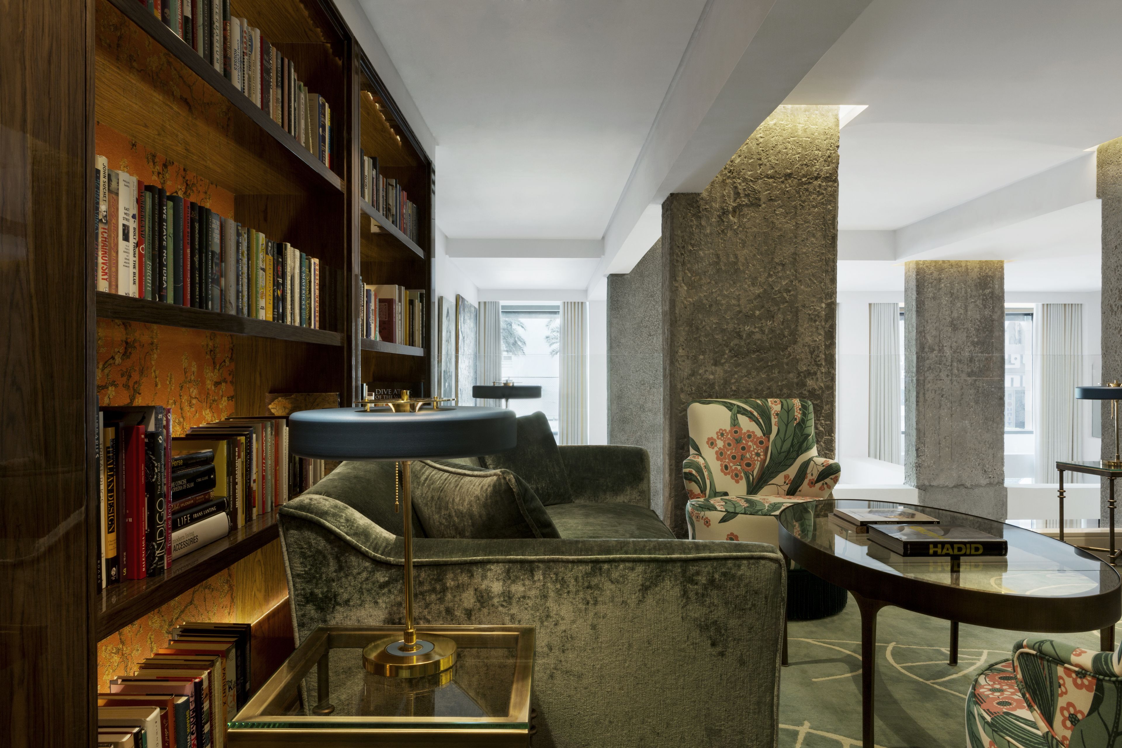 Una biblioteca con estanterías, un sofá y una mesa de centro.
