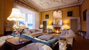 A luxurious living room with a fireplace, plush sofas, and elegant decor. - Wardhill Castle (Inverurie)