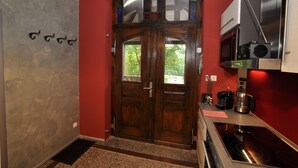 A kitchen with a double door, a microwave, and a stove. - Apartment Alpha, haven of peace with complete facilities (Weenzen)