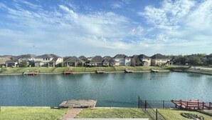 A residential area with houses and a lake.