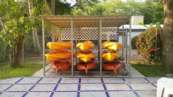 Relax in a serene garden setting surrounded by lush greenery and a unique metal structure.