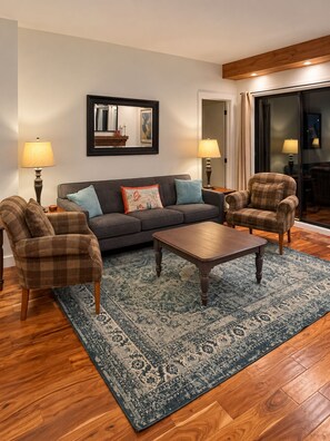A living room with a sofa, two armchairs, a coffee table, and a patterned rug. - Highest Rated, Lowest Rates in Snow Blaze: 2/2, A/C, Pool, Hot Tub, Gym, Firepit (Park City)