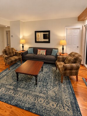 A living room with a sofa, two armchairs, a coffee table, and two lamps. - Highest Rated, Lowest Rates in Snow Blaze: 2/2, A/C, Pool, Hot Tub, Gym, Firepit (Park City)