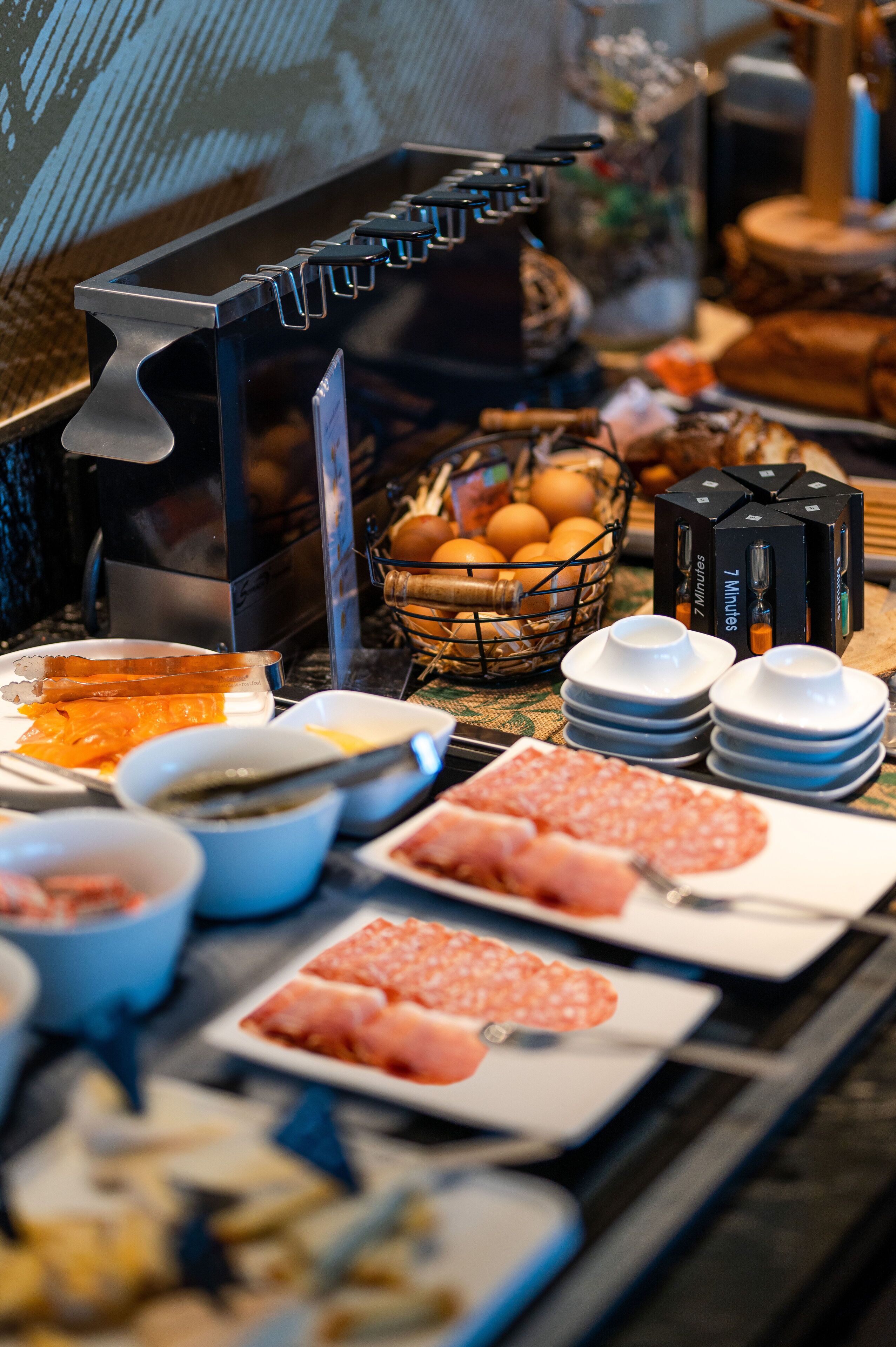 A buffet with various food items and condiments.