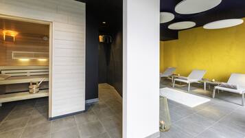 Unwind in our serene spa area, featuring a sauna and relaxation lounge with comfortable seating.