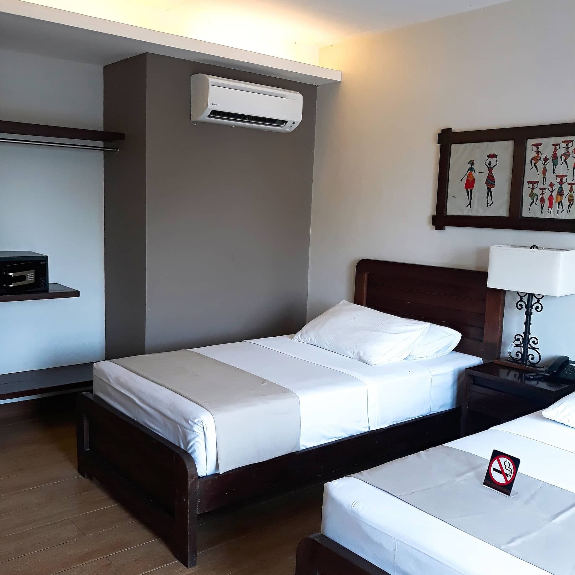 superior deluxe twin | premium bedding, individually decorated, desk, laptop workspace