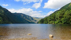 A calm lake surrounded by forested hills. - The Nook County Dublin (Shankill)