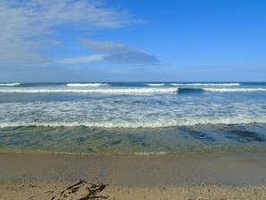 Rannalla, aurinkotuoleja, rantapyyhkeitä