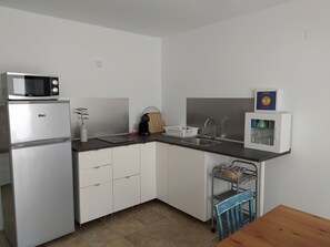 Fridge, microwave, stovetop, coffee/tea maker
