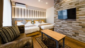 A modern hotel room with two beds, a flat-screen TV mounted on a textured wall, a leather sofa, and a wooden coffee table. - HOTEL -sui- HARUYOSHI (Fukuoka)