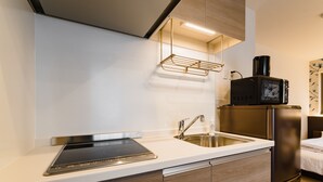 A modern kitchen with a built-in stove, sink, and stainless steel appliances. - HOTEL -sui- HARUYOSHI (Fukuoka)