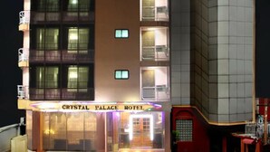 A hotel named Crystal Palace Hotel with a modern facade, multiple balconies, and a well-lit entrance. - Crystal Palace Hotel (Yangon)