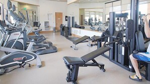 A gym with treadmills, weight machines, and a bench. - Fv62884 - Regal Oaks - 4 Bed 3.5 Baths Townhome (Kissimmee)