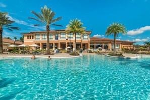 A hotel with a large swimming pool, palm trees, and outdoor seating areas. - Fv62884 - Regal Oaks - 4 Bed 3.5 Baths Townhome (Kissimmee)