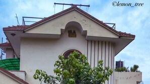 A building with a classical architectural style, featuring a central pediment and columns. - Lemon Tree Apartment and Homestay (Tohka)