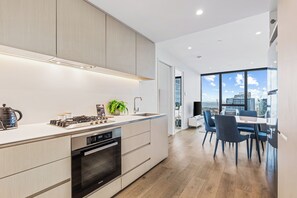Two Bedroom One Bathroom Sky High Apartment | Private kitchen | Full-size fridge, microwave, oven, stovetop - CLLIX Australia 108 Apartments (Southbank)