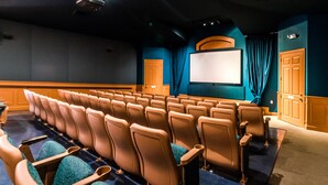 A theater with rows of seats, a screen, and curtains. - Ip60128 - Windsor Palms Resort - 2 Bed 2 Baths Condo (Kissimmee)