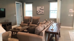 A living room with a sofa set, a coffee table, and a TV. - Aco258800 - The Encore Club Resort - 8 Bed 6.5 Baths Villa (Kissimmee)