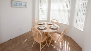 A dining area with a round table, four chairs, and a ceiling light. - Ip60350 - Fiesta Key - 3 Bed 2.5 Baths Townhome (Kissimmee)