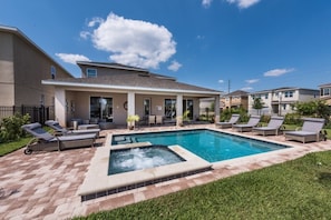 A residential property with a swimming pool, outdoor seating, and a well-maintained lawn. - Aco245706 - The Encore Club Resort - 8 Bed 8 Baths Villa (Kissimmee)