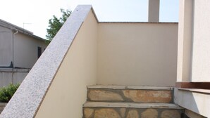 A set of stone steps leading up to a building entrance. - Apartments Blato-M (Pag)