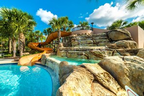 A pool with a water slide, palm trees, and a clear blue sky. - Aco92227 - Solterra Resort - 5 Bed 4.5 Baths Villa (Davenport)