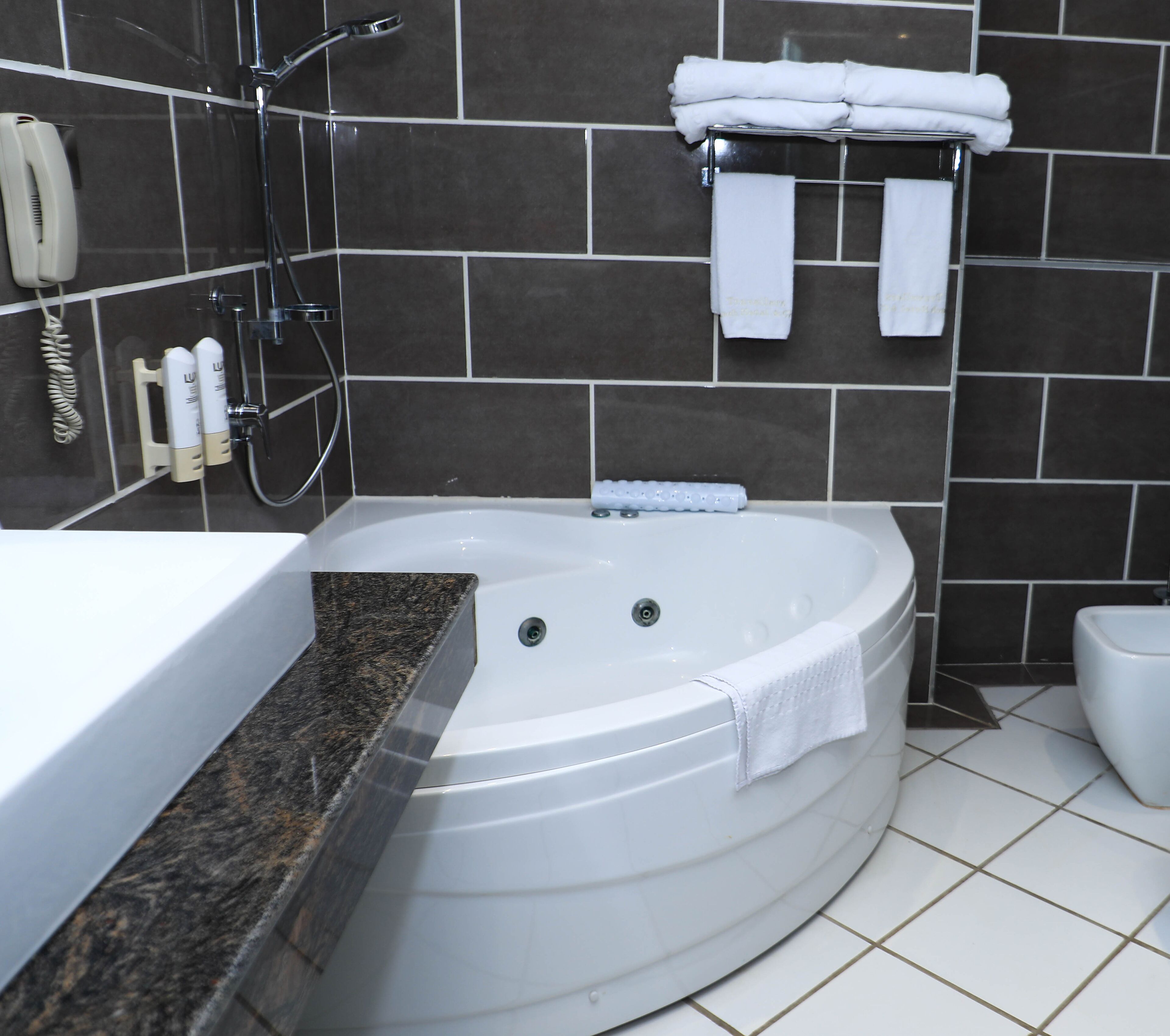 junior suite | bathroom | separate bathtub and shower, rainfall showerhead, free toiletries