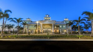 A large, two-story hotel with a central entrance, multiple balconies, and a clock tower. - Je63118 - The Encore Club Resort - 6 Bed 5.5 Baths Villa (Kissimmee)