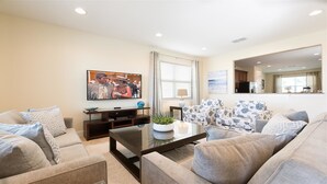 A modern living room with a sofa set, a coffee table, and a flat-screen TV mounted on the wall. - Je63118 - The Encore Club Resort - 6 Bed 5.5 Baths Villa (Kissimmee)
