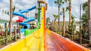 A water park with multiple slides in blue, green, yellow, and orange. - Je63118 - The Encore Club Resort - 6 Bed 5.5 Baths Villa (Kissimmee)