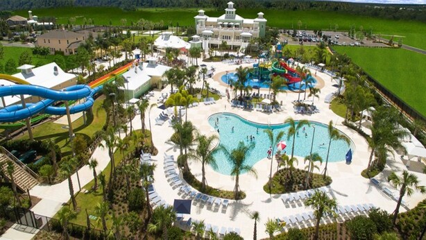 A resort with a large pool, water slides, and a beach area. - Je63118 - The Encore Club Resort - 6 Bed 5.5 Baths Villa (Kissimmee)