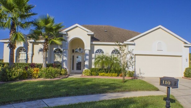 A single-story house with a garage, a well-maintained lawn, and a mailbox with the number 110. - Ip60389 - Highlands Reserve - 5 Bed 3 Baths Villa (Davenport)