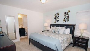 A bedroom with a large bed, two bedside tables, a dresser, a mirror, and a ceiling light. - Fv62387 - The Dales at West Haven - 7 Bed 6 Baths Villa (Davenport)