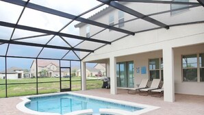 A covered swimming pool area with a hot tub, lounge chairs, and a view of neighboring houses. - Fv62387 - The Dales at West Haven - 7 Bed 6 Baths Villa (Davenport)