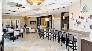 A spacious dining area with a long counter and multiple chairs, a ceiling fan, and pendant lighting. - Ip60500 - Solterra Resort - 6 Bed 4 Baths Villa (Davenport)