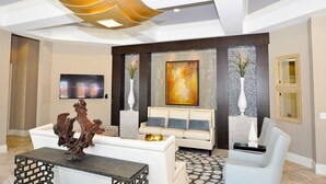 A modern living room with a white sofa, a coffee table, and a unique ceiling light fixture. - Ip60500 - Solterra Resort - 6 Bed 4 Baths Villa (Davenport)