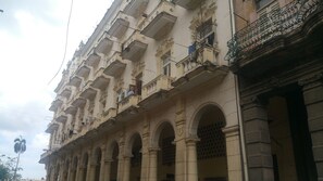 A multi-story building with ornate balconies and arched windows. - Jerome's Old Havana Apartment (Havana)
