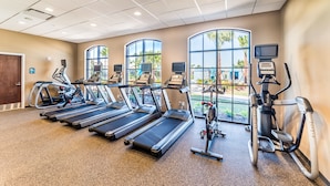 A gym with treadmills, elliptical machines, and stationary bikes. - Aco234120 - Windsor At Westside Resort - 4 Bed 3 Baths Townhome (Kissimmee)