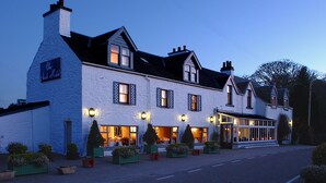 A large, white building with multiple windows and a covered entrance area, likely a hotel or similar accommodation. - The Airds Hotel & Restaurant (Appin)