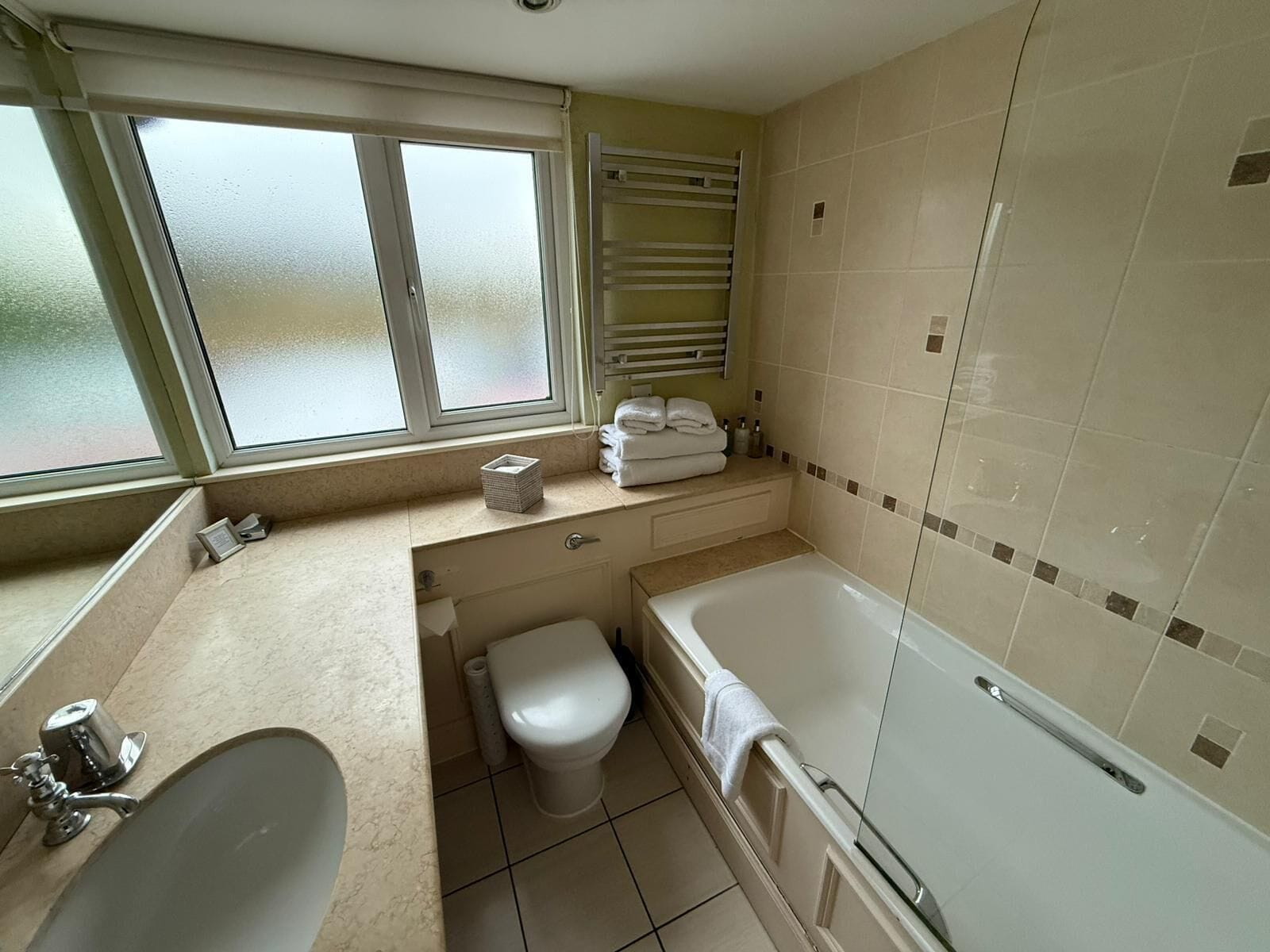 A bathroom with a bathtub, toilet, and sink.