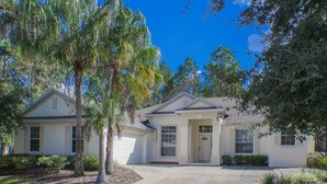 A two-story house with a front driveway, a garage, and a well-maintained lawn. - Ip60121 - Highlands Reserve - 4 Bed 2 Baths Villa (Davenport)