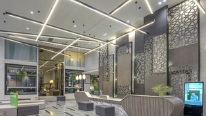 A modern lobby with a marble floor, contemporary furniture, and geometric light fixtures. - Zenseana Resort & Spa (Patong)