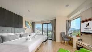 A modern hotel room with a large bed, a desk, a chair, and a TV. - Zenseana Resort & Spa (Patong)