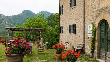 Experience the charm of this traditional restaurant, surrounded by a serene garden with lush greenery and a picturesque pergola.