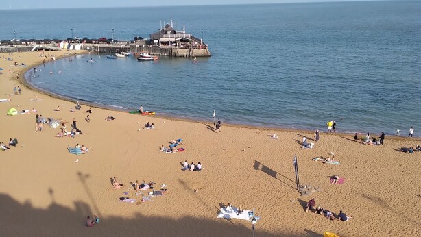A beach with a pier and a lifeguard tower. - Shenandoah House (Margate)