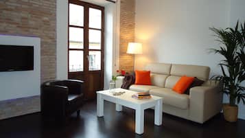 Apartment, 1 Bedroom, Balcony | Living room | Flat-screen TV