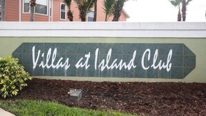 A sign for 'Villa at Island Club' with a green background and white lettering. - Ip60497 - Island Club West - 3 Bed 2 Baths Condo (Kissimmee)