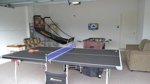 A ping pong table in a room with a bunk bed, a TV, and a foosball table. - Ip60503 - The Shire at West Haven - 4 Bed 3 Baths Villa (Davenport)