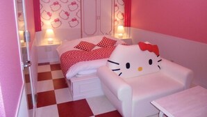 A pink-themed bedroom with a bed, a Hello Kitty chair, and a wardrobe. - HOTEL MOULIN ROUGE - Adults Only (Ibaraki)